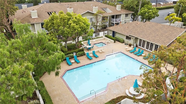 community pool with a patio and french doors