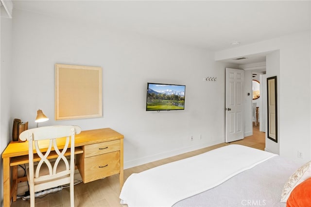 bedroom featuring light wood-type flooring and baseboards