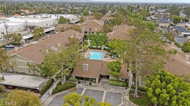 aerial overview of property's location with nearby suburban area and a pool area