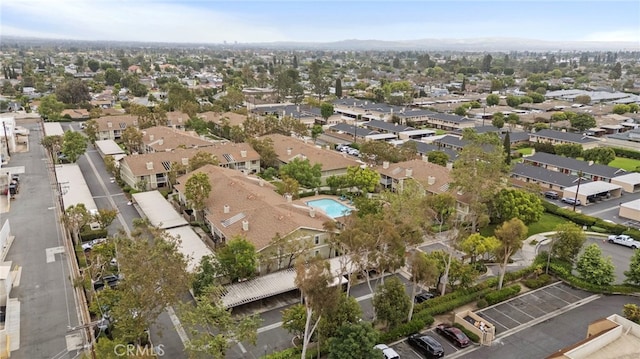 aerial view of property and surrounding area featuring nearby suburban area