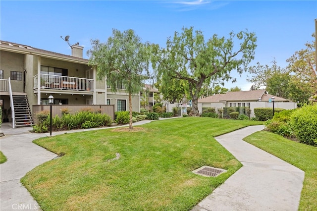 surrounding community featuring a lawn and stairs