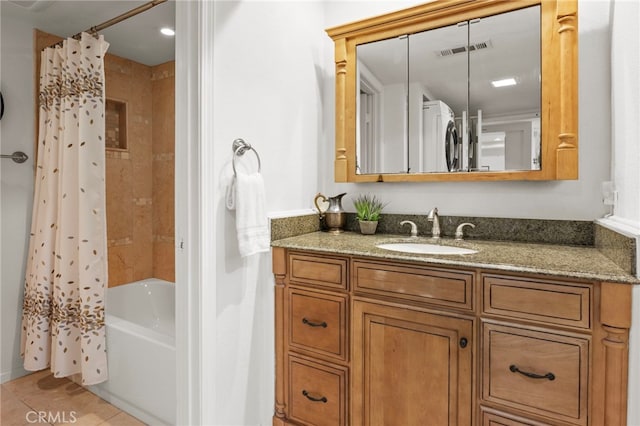 full bath featuring vanity, shower / tub combo, and tile patterned floors