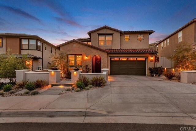 940 Lindbergh Dr, San Marcos, CA 92069 - mediterranean / spanish house featuring driveway, an attached garage, a tiled roof, and stucco siding