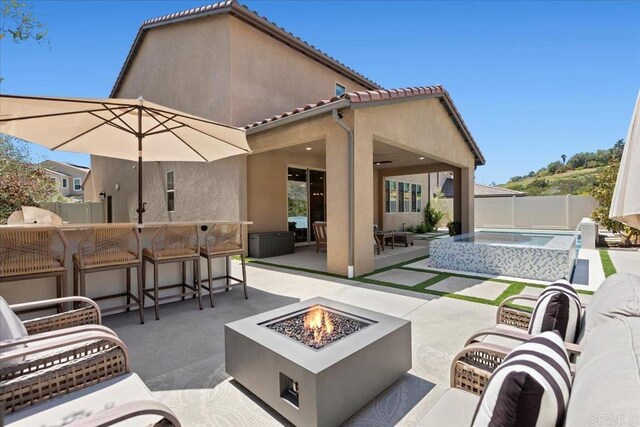 940 Lindbergh Dr, San Marcos, CA 92069 - fenced backyard with a patio area, an outdoor living space with a fire pit, and an outdoor hot tub
