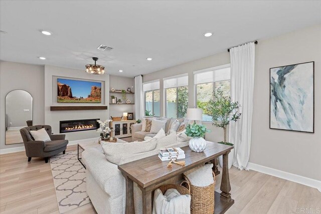 940 Lindbergh Dr, San Marcos, CA 92069 - living room with light wood finished floors, recessed lighting, and a glass covered fireplace