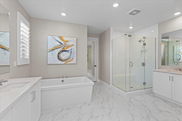 940 Lindbergh Dr, San Marcos, CA 92069 - bathroom featuring marble look tiles, two vanities, a stall shower, a freestanding bath, and recessed lighting