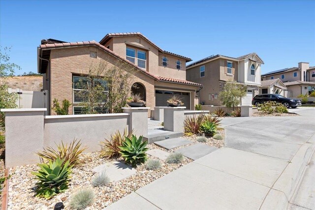 940 Lindbergh Dr, San Marcos, CA 92069 - view of front facade featuring a garage, a fenced front yard, a tile roof, and driveway