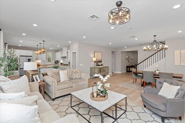 940 Lindbergh Dr, San Marcos, CA 92069 - living area with a chandelier, light wood-type flooring, recessed lighting, and stairway
