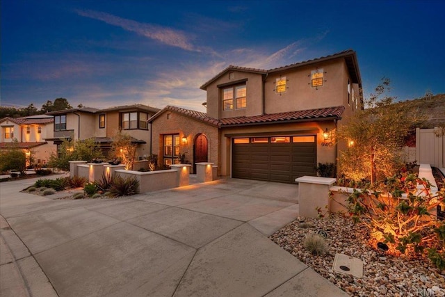 940 Lindbergh Dr, San Marcos, CA 92069 - mediterranean / spanish-style home featuring driveway, an attached garage, a tile roof, and stucco siding