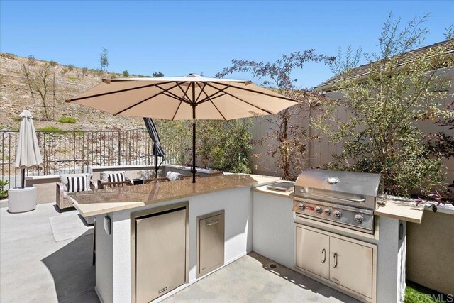 940 Lindbergh Dr, San Marcos, CA 92069 - fenced backyard featuring exterior kitchen and a patio area