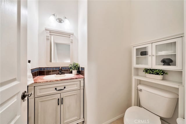 half bathroom featuring toilet and vanity