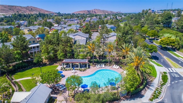 aerial view of property's location featuring a mountainous background and a pool