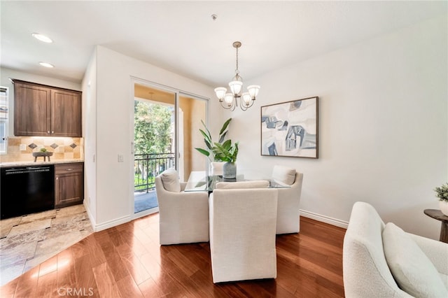 dining room with a chandelier, wood finished floors, baseboards, and recessed lighting