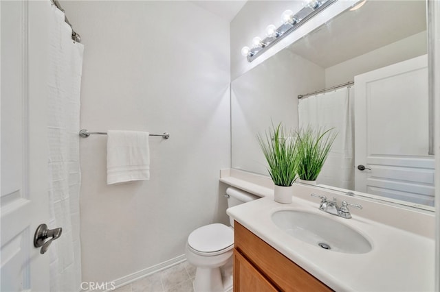full bathroom featuring toilet, vanity, tile patterned floors, and baseboards