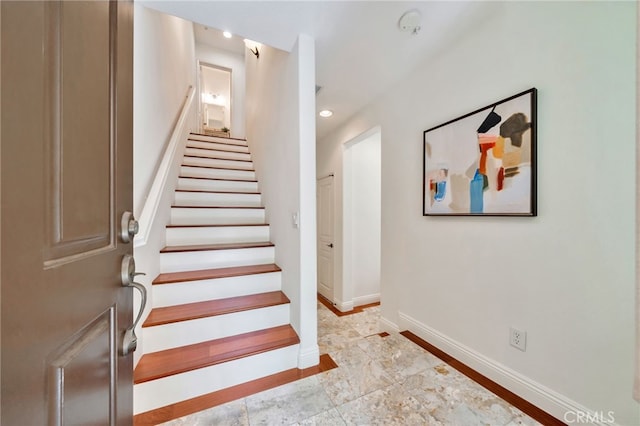 stairs with baseboards and recessed lighting