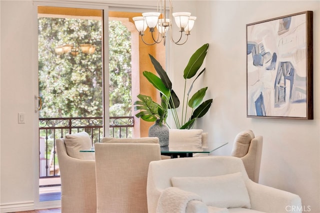 dining space featuring a chandelier, plenty of natural light, and wood finished floors