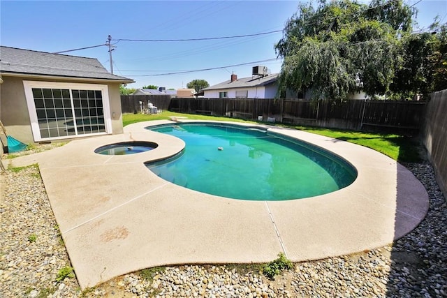 view of pool with a fenced backyard, a patio, and an in-ground hot tub
