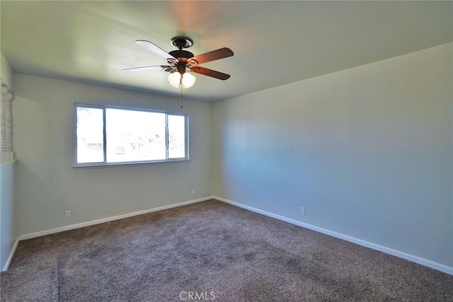 spare room with carpet floors, a ceiling fan, and baseboards