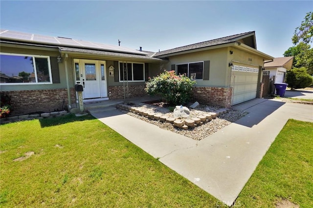 ranch-style house with brick siding, a front yard, solar panels, driveway, and an attached garage