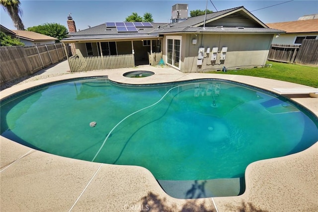 view of pool featuring a patio area, a fenced backyard, an in-ground hot tub, a diving board, and central air condition unit