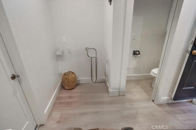 1151 W 14th St, San Pedro, CA 90731 - bathroom featuring toilet, wood finished floors, and baseboards