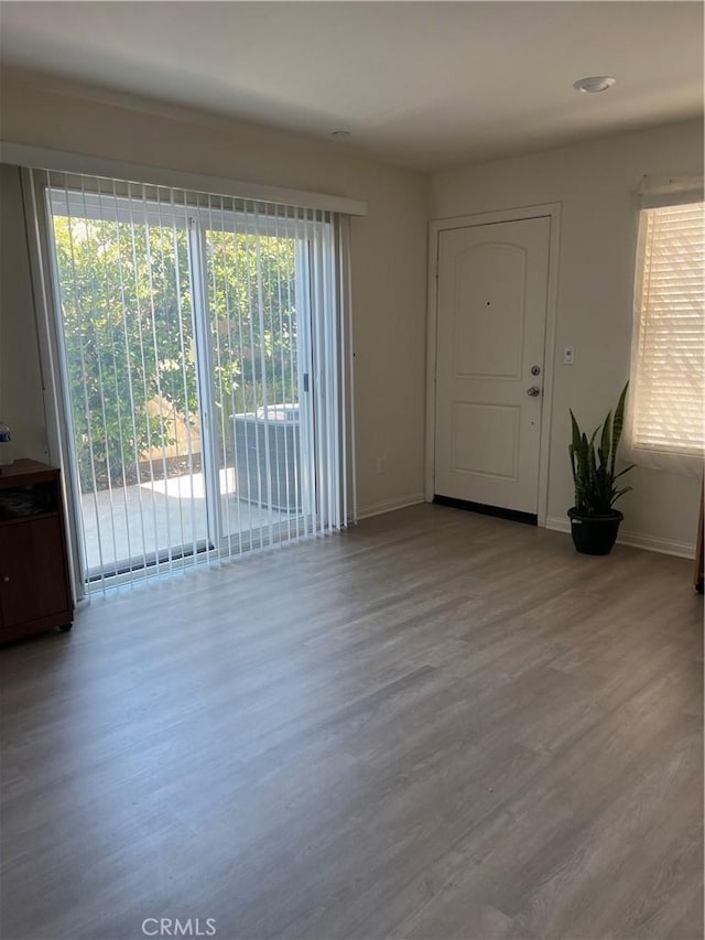 unfurnished room with wood finished floors and baseboards