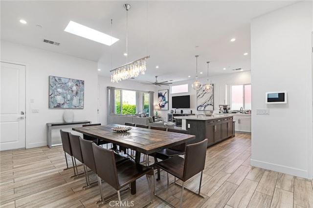 54060 Avenida Madero Ln, Quinta, CA 92253 - dining space with a skylight, light wood-style flooring, recessed lighting, a ceiling fan, and baseboards