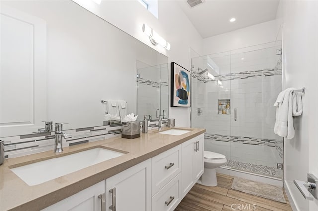 54060 Avenida Madero Ln, Quinta, CA 92253 - bathroom with a shower stall, double vanity, tasteful backsplash, recessed lighting, and wood finished floors
