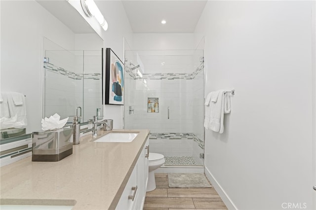 54060 Avenida Madero Ln, Quinta, CA 92253 - full bathroom with double vanity, toilet, a stall shower, recessed lighting, and wood finished floors
