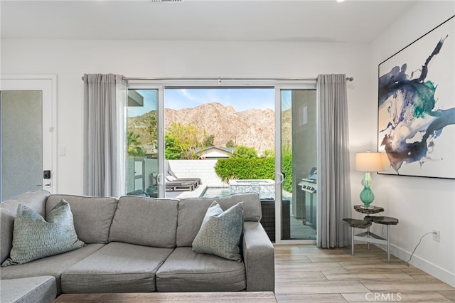 54060 Avenida Madero Ln, Quinta, CA 92253 - living room featuring plenty of natural light, a mountain view, wood finished floors, and baseboards