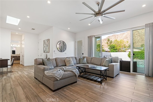 54060 Avenida Madero Ln, Quinta, CA 92253 - living room with light wood-style flooring, a skylight, a ceiling fan, recessed lighting, and baseboards