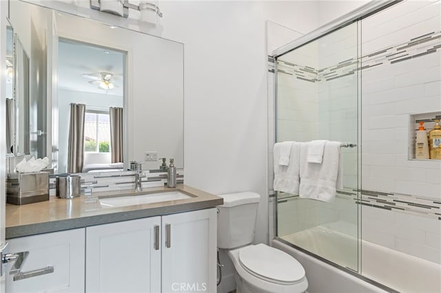 54060 Avenida Madero Ln, Quinta, CA 92253 - bathroom with shower / bath combination with glass door, toilet, vanity, and ceiling fan