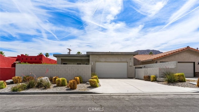 54060 Avenida Madero Ln, Quinta, CA 92253 - view of front of property featuring a garage, concrete driveway, and stucco siding