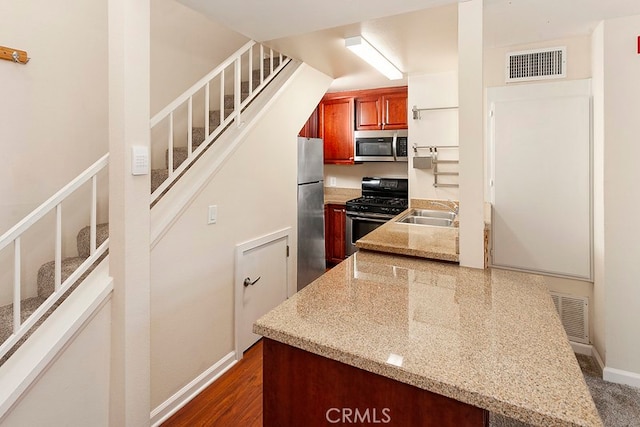 5530 Owensmoutth Ave Unit 306, Woodland Hills, CA 91367 - kitchen with stainless steel appliances, light stone countertops, a sink, and baseboards