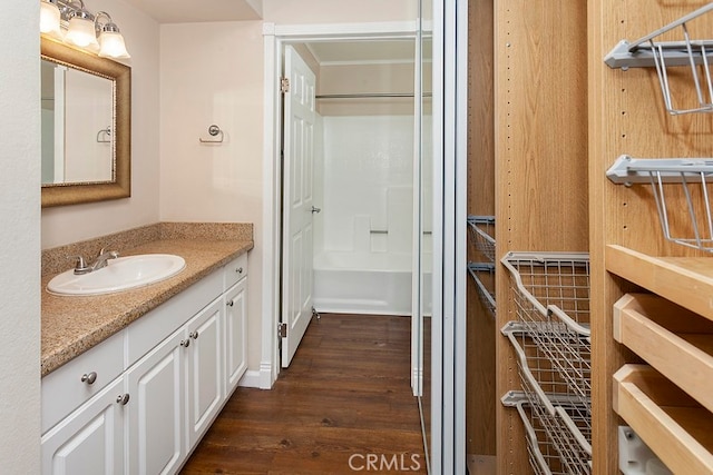 5530 Owensmoutth Ave Unit 306, Woodland Hills, CA 91367 - bathroom featuring wood finished floors and vanity