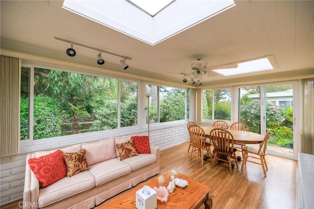 3268 San Amadeo Unit C, Laguna Woods, CA 92637 - sunroom / solarium with a skylight, track lighting, and wood finished floors