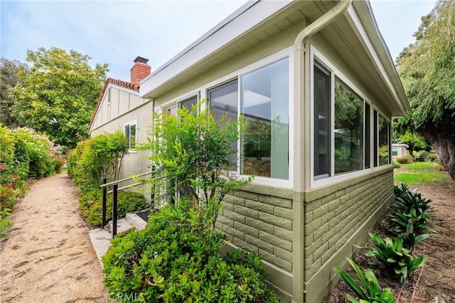 3268 San Amadeo Unit C, Laguna Woods, CA 92637 - view of side of property featuring a chimney