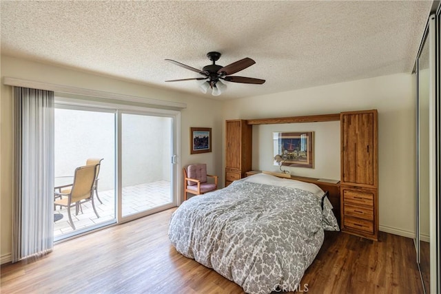 3268 San Amadeo Unit C, Laguna Woods, CA 92637 - bedroom featuring access to outside, wood finished floors, a textured ceiling, baseboards, and ceiling fan