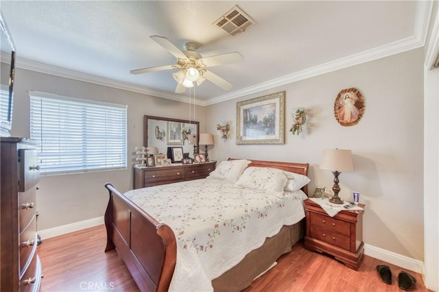 bedroom featuring baseboards, light wood-style flooring, crown molding, and a ceiling fan