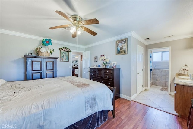 bedroom featuring wood finished floors, ornamental molding, a sink, a ceiling fan, and baseboards