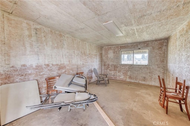 unfurnished room featuring unfinished concrete floors
