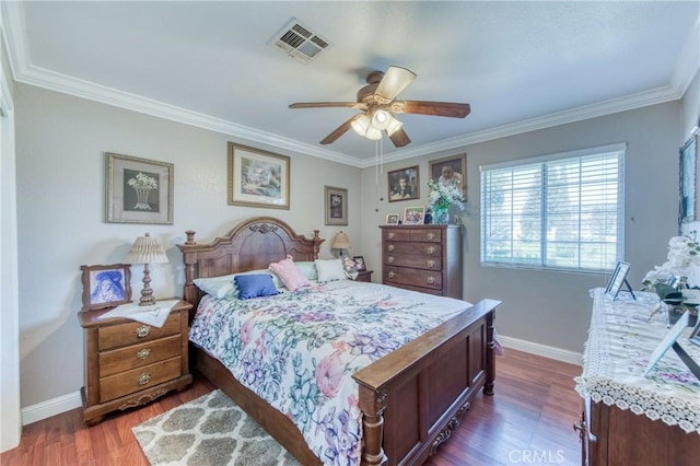 bedroom featuring ornamental molding, dark wood-style flooring, baseboards, and a ceiling fan