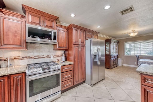 kitchen featuring stainless steel appliances, crown molding, decorative backsplash, recessed lighting, and baseboards