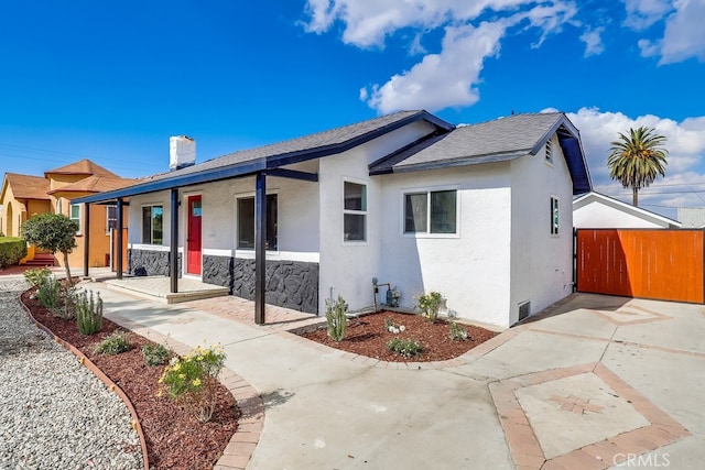 1847 W 74th St, Los Angeles, CA 90047 - view of front facade with a porch, stucco siding, fence, and a chimney