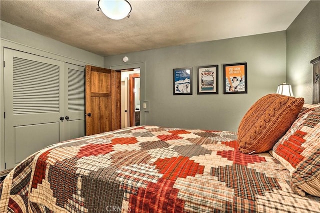 bedroom with a closet and a textured ceiling
