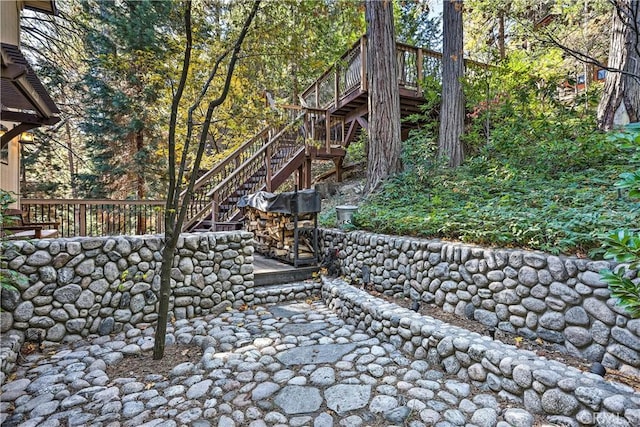 view of yard featuring stairs and a deck