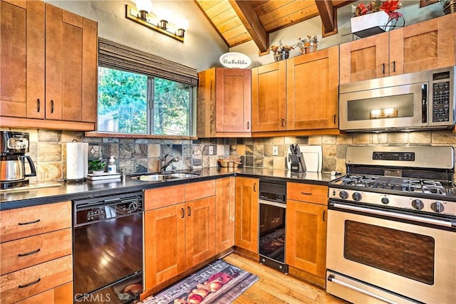 kitchen featuring appliances with stainless steel finishes, wood ceiling, a sink, light wood finished floors, and dark countertops
