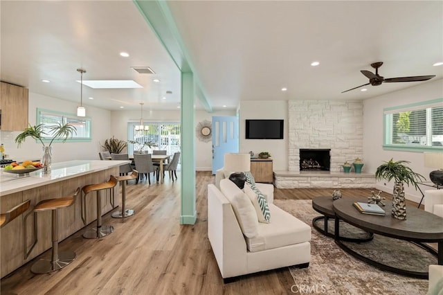 225 S Guadalupe Ave, Redondo Beach, CA 90277 - living area with light wood-style floors, a fireplace, recessed lighting, and a skylight