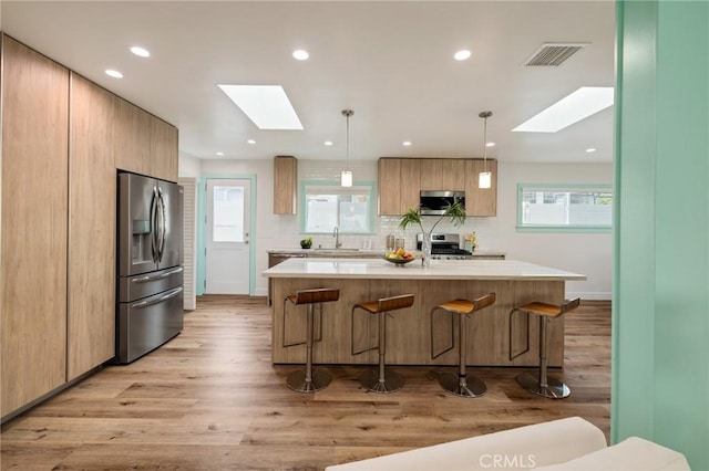 225 S Guadalupe Ave, Redondo Beach, CA 90277 - kitchen featuring a skylight, appliances with stainless steel finishes, a breakfast bar area, and recessed lighting