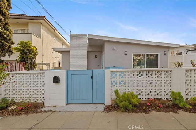 225 S Guadalupe Ave, Redondo Beach, CA 90277 - view of front of property featuring a gate, stucco siding, and a fenced front yard